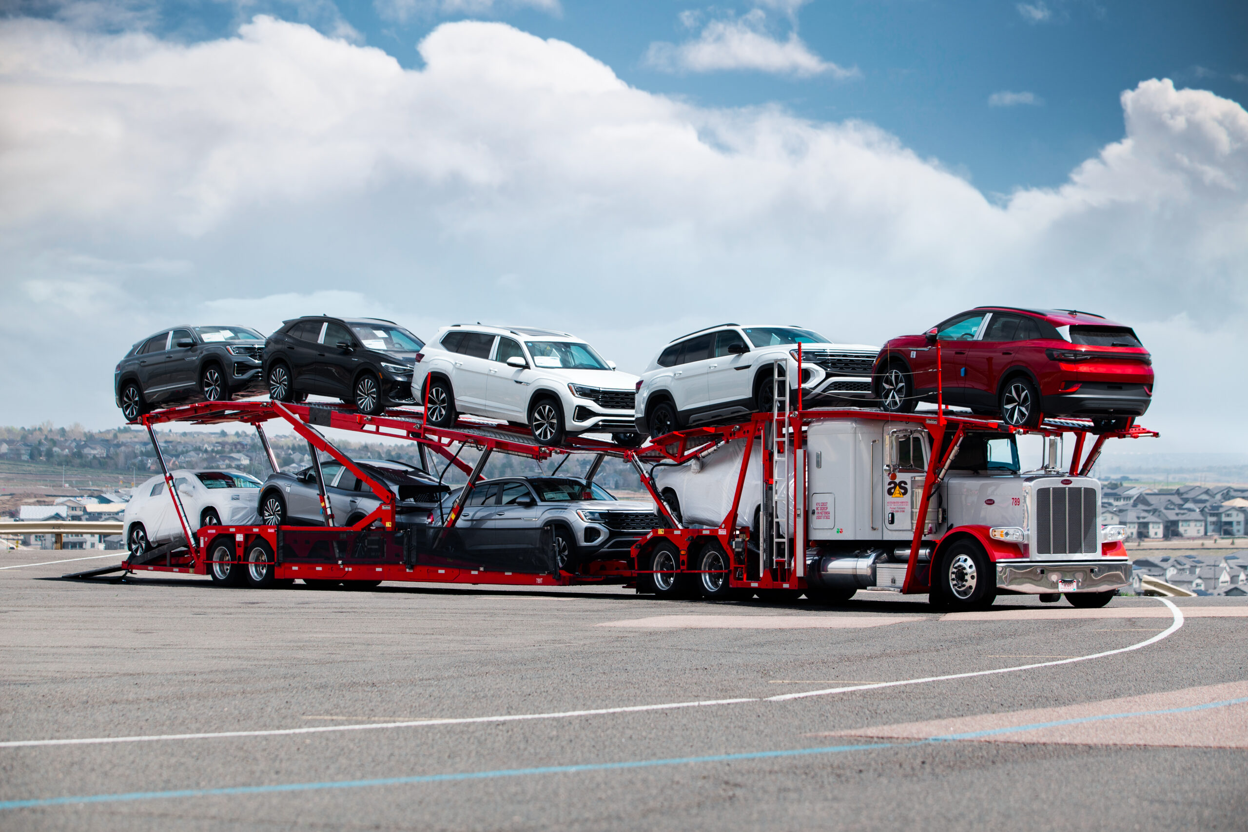 Accelerated car hauler loaded at a vehicle yard