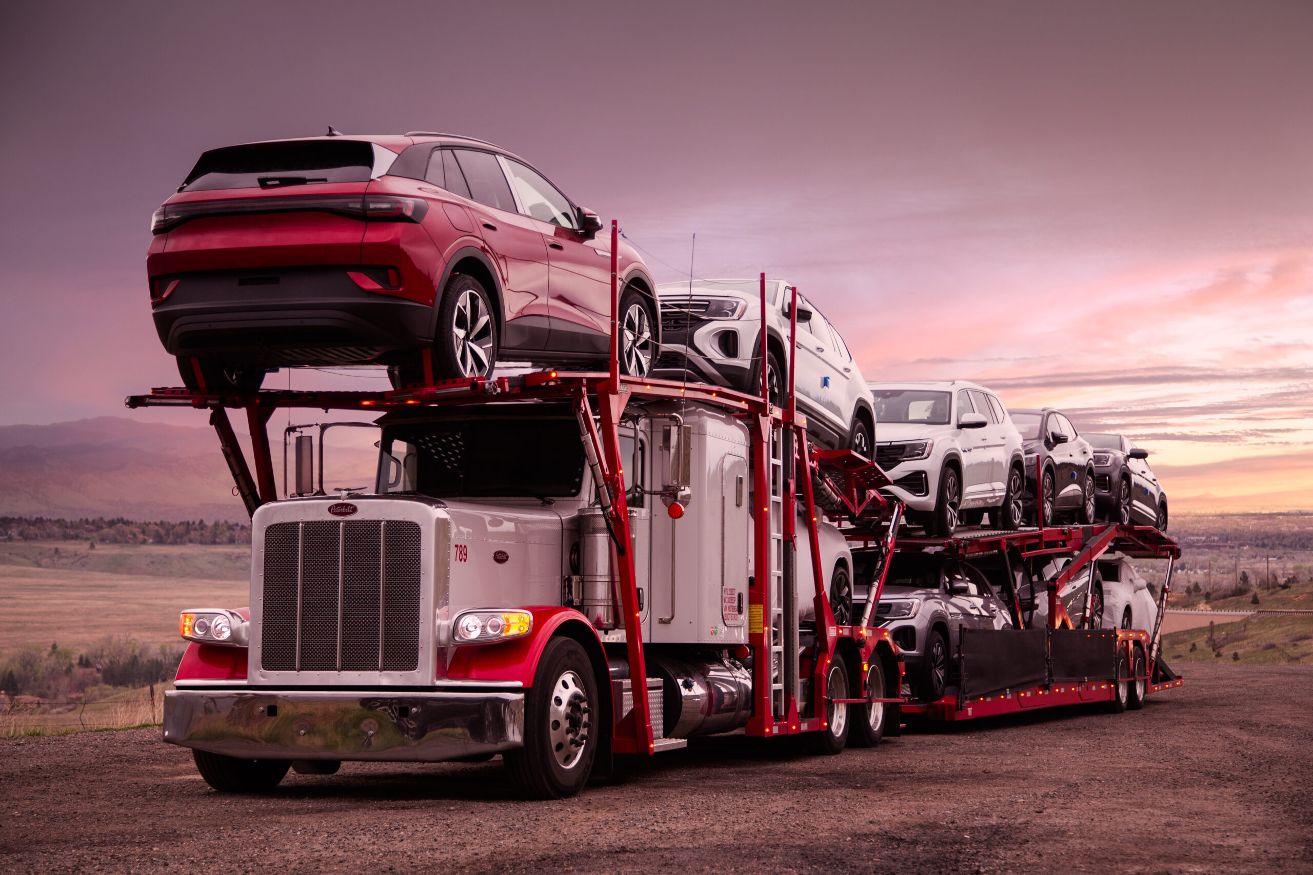 Accelerated Peterbilt car hauler loaded with new vehicles