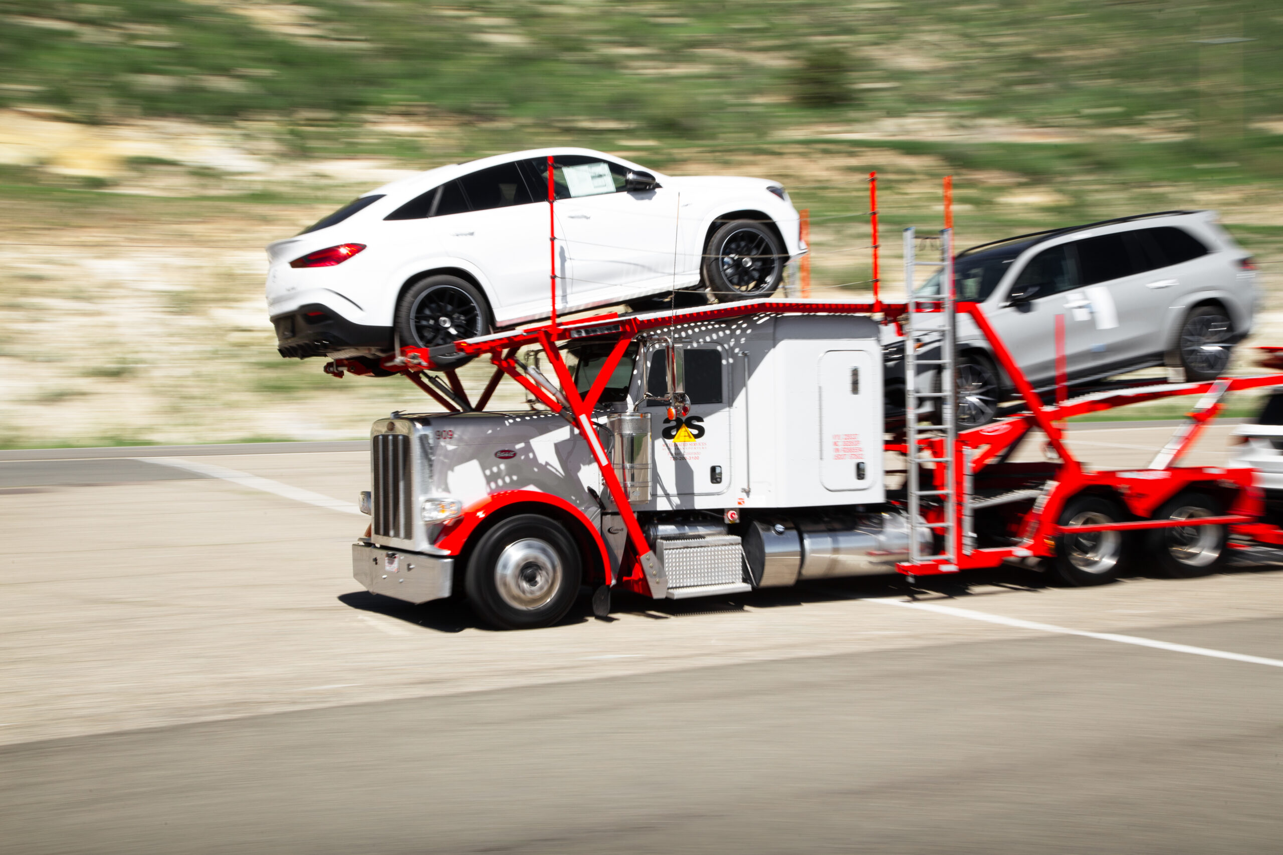 Accelerated car hauler trailer loaded with vehicles